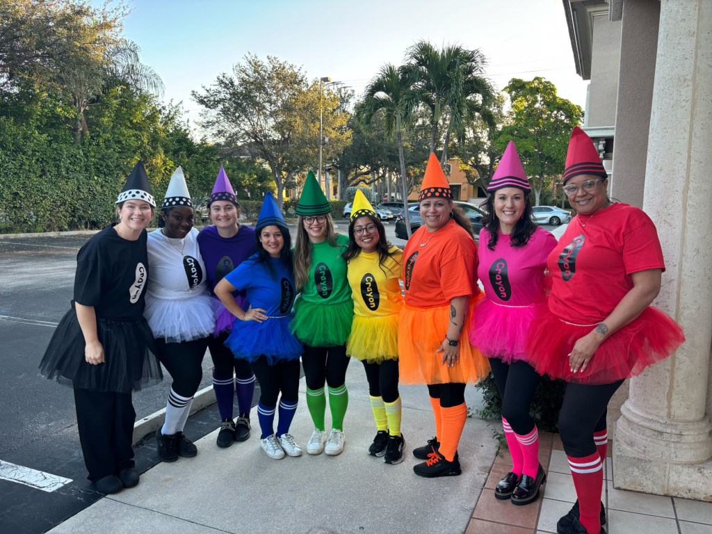 Staff members wearing a rainbow costume
