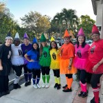 Staff members wearing a rainbow costume