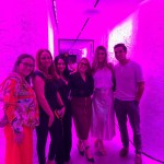 Staff on a room with a pink lighting effect