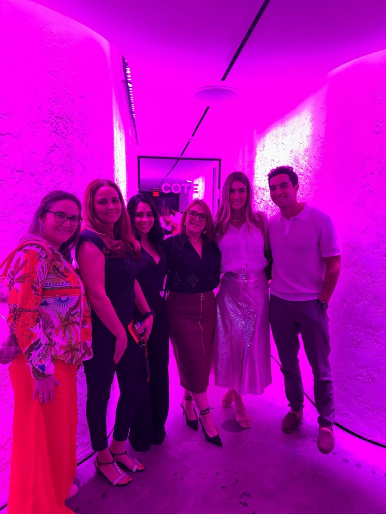 Staff on a room with a pink lighting effect