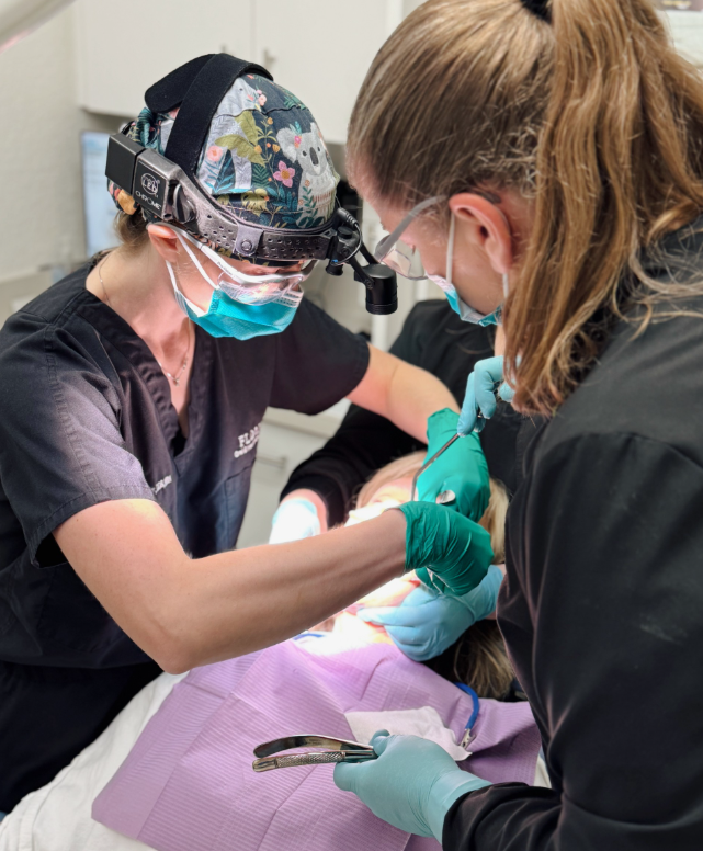 A doctor and staff during a dental procedure